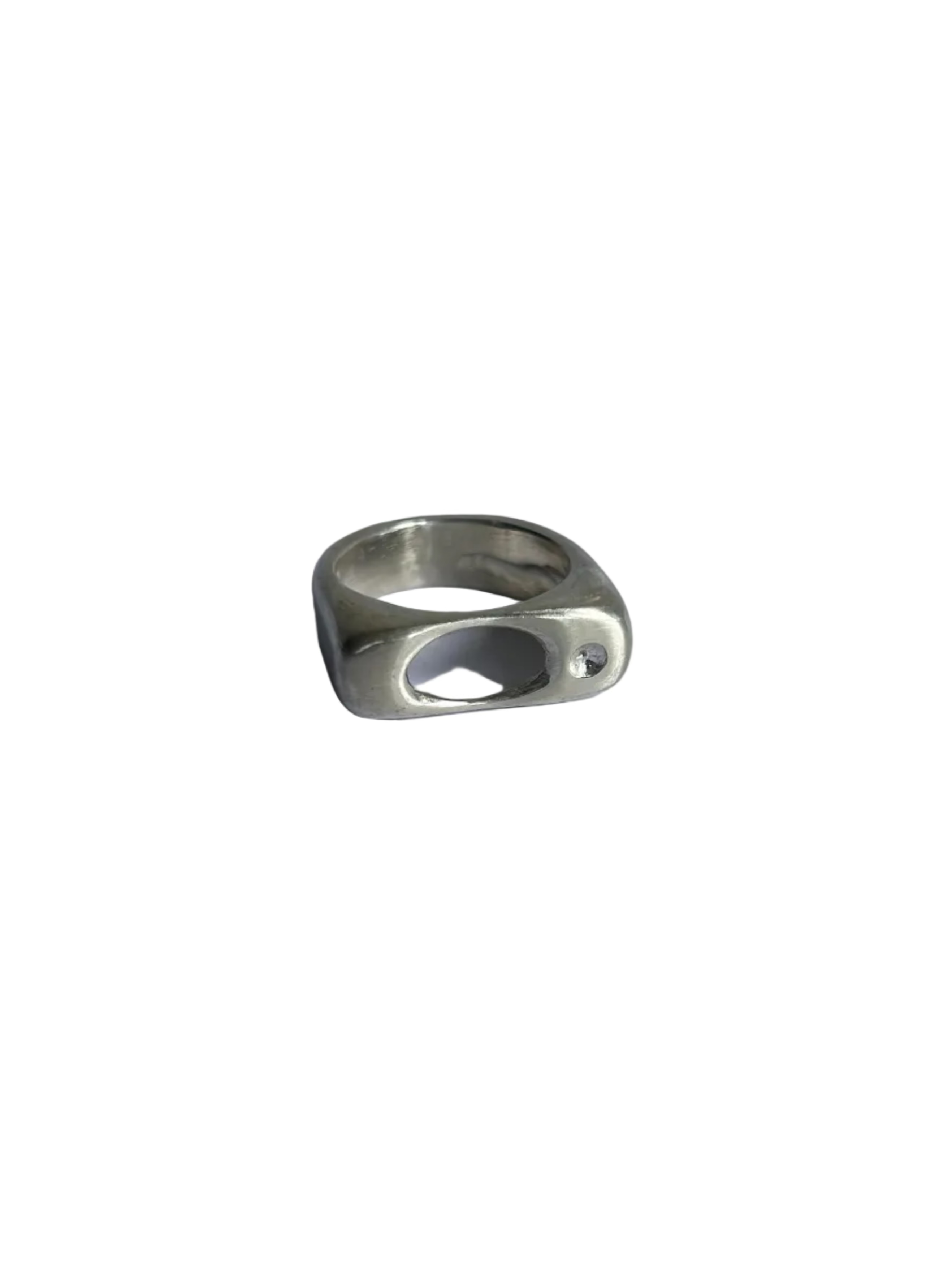 A silver-toned metal ring with a unique, organic openwork design, photographed on a plain light gray background.